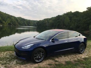Tesla in Front of Lake