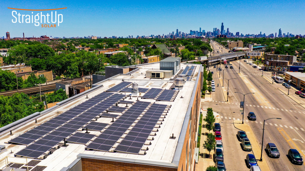 Solar on roof of Lawndale Christian Health Center. Chicago skyline can be seen in the distance.